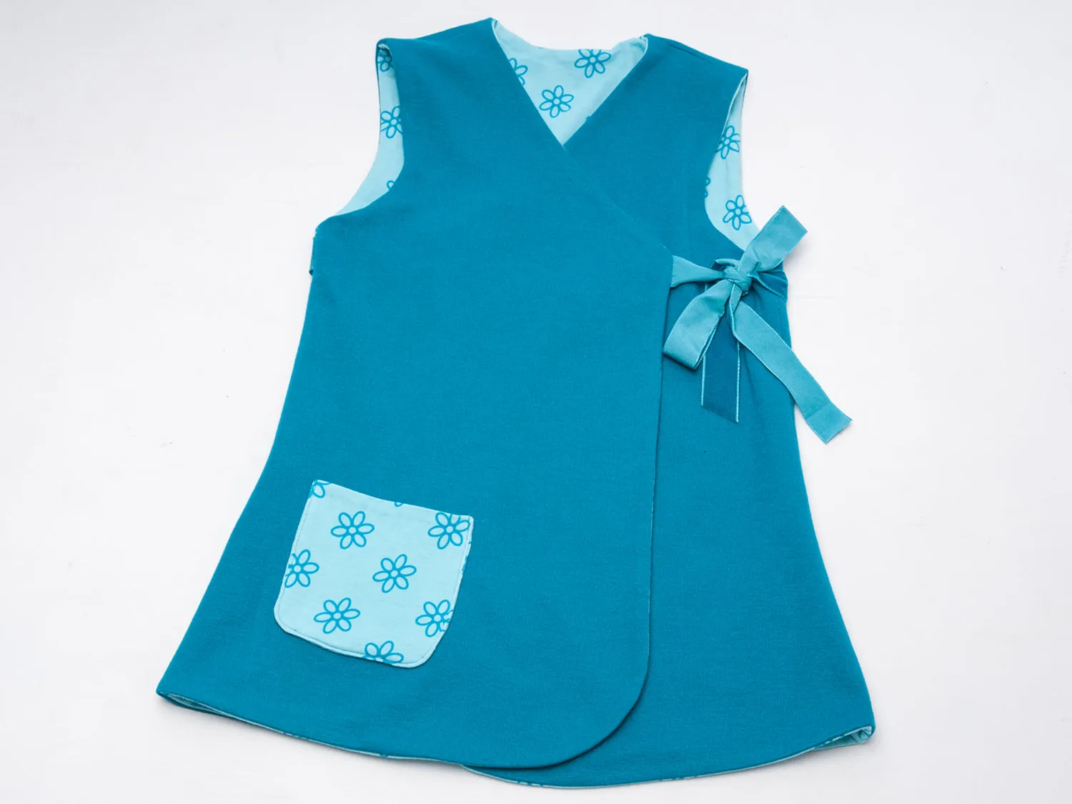 Lined baby tunic wrap dress pattern for girls. Easy sewing reversible dress with or without sleeves. Paper pattern MARIE by Patternforkids