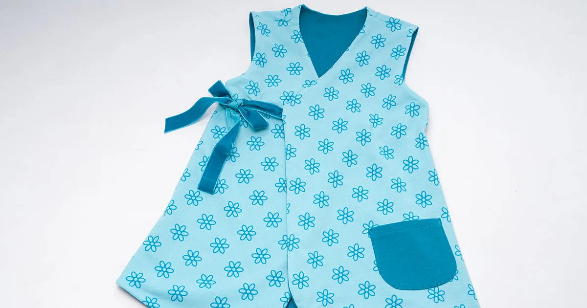 Lined baby tunic wrap dress pattern for girls. Easy sewing reversible dress with or without sleeves. Paper pattern MARIE by Patternforkids